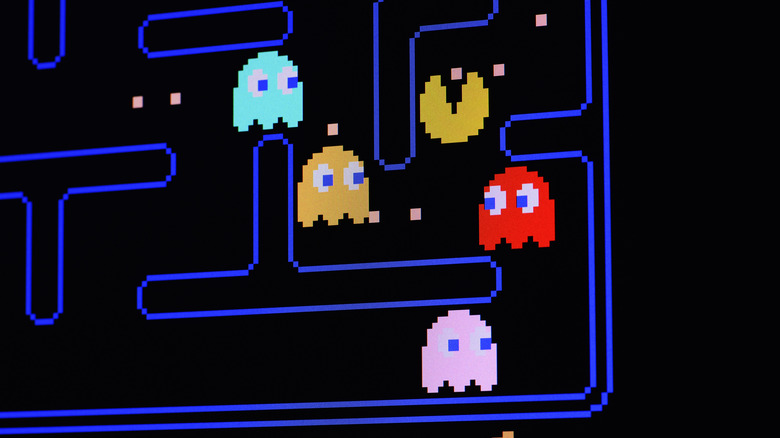 Pac-Man eating dots as ghosts follow in Pac-Man