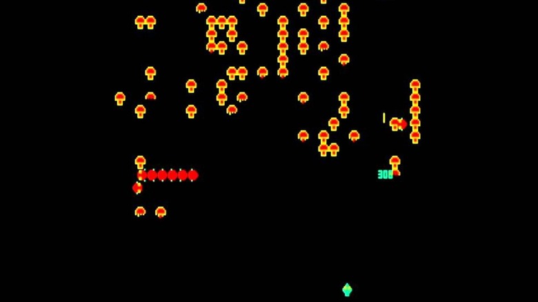 A green ship shoots at mushroom in Centipede