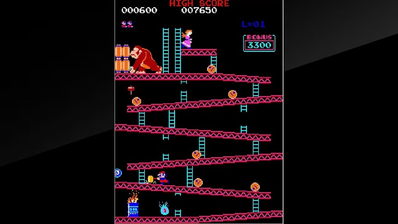 Mario runs up a ramp with a hammer in Donkey Kong