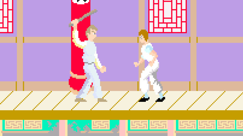Thomas fights a man holding a club in "Kung-Fu Master" (1984)