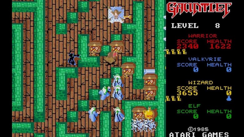A hero grabs a teasure while evil wizards swarm behind him in "Gauntlet"