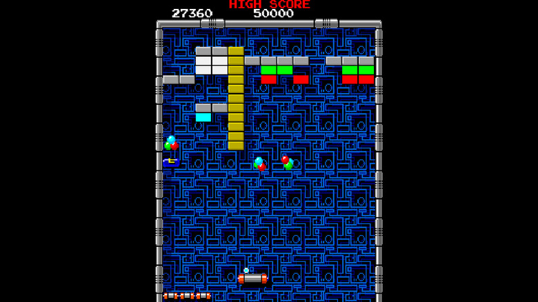 The paddle deflects a ball in Arkanoid