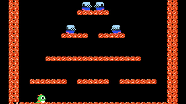 Bob sits at the bottom of a stage in Bubble Bobble