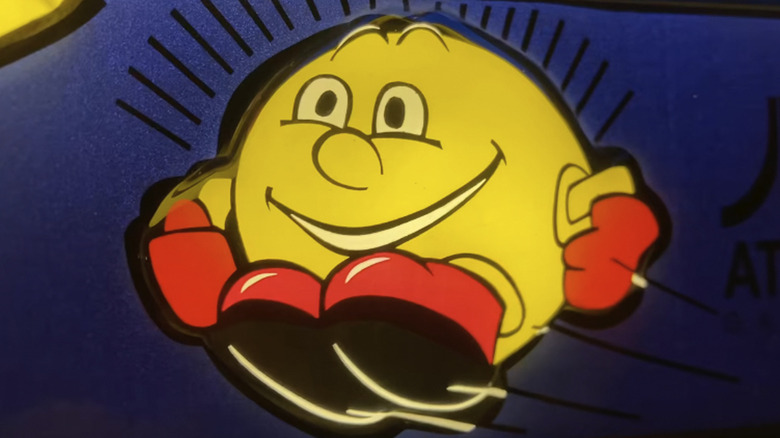 Pac-Man smiles triumphantly on a North American arcade cabinent for Pac-Mania