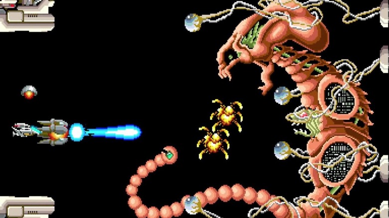 The player spaceship blasts a large extraterrestrial in R-Type