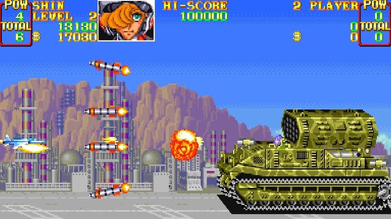 A fighter jet attacks a large tank firing missiles in U.N. Squadron