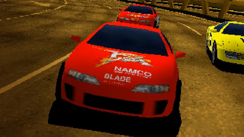 A red race car leads two other cars in Ridge Racer