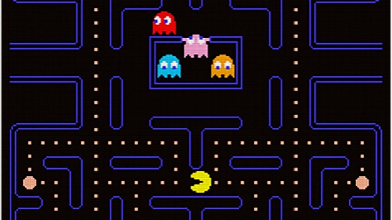 The ghosts emerge from a central block with Pac-Man surrounded by dots below them in Pac-Man