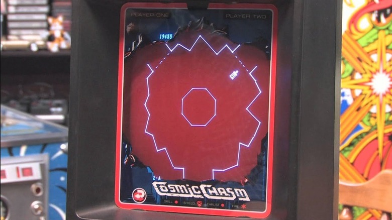 A look at a Cosmic Chasm arcade cabinet as a ship moves towards a forcefield