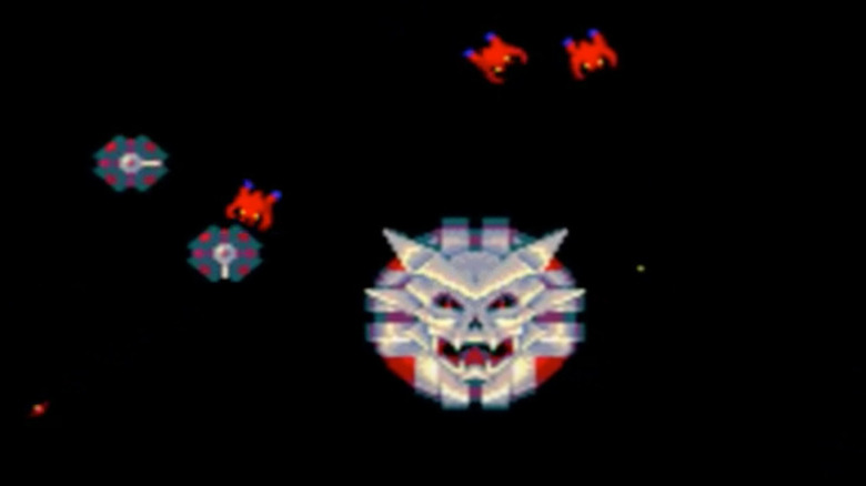 Sinistar roars around worker spaceships in Sinistar