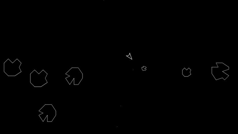 A triangular spaceship faces incoming asteroids in Asteroids