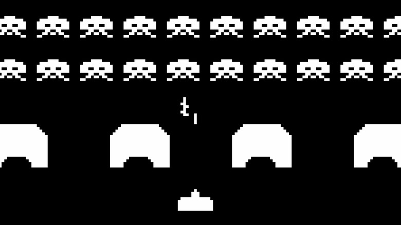 A cannon exchanges fire with descending enemies in Space Invaders
