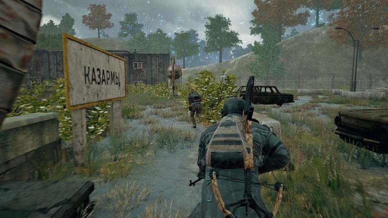 Soldiers run through an overgrown parking lot in PUBG: Battlegrounds