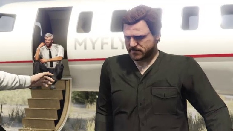 Solomun standing in front of a plane in a screenshot from Grand Theft Auto Online