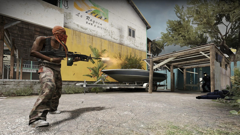 A terrorist fires a machine gun at counter-terrorists in Counter-Strike: Global Offensive