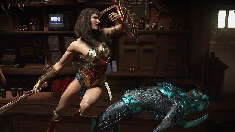 Wonder Woman strikes Blue Beetle with her shield in Injustice 2