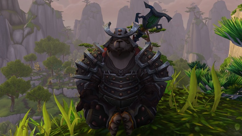 A pandaren monk meditates on a grassy hill in "World of Warcraft" (2004)
