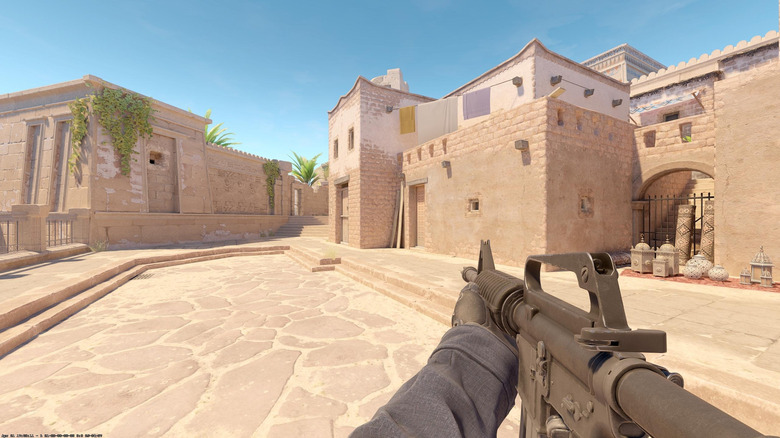 A player holds an assault rifle in a courtyard in Counter-Strike 2