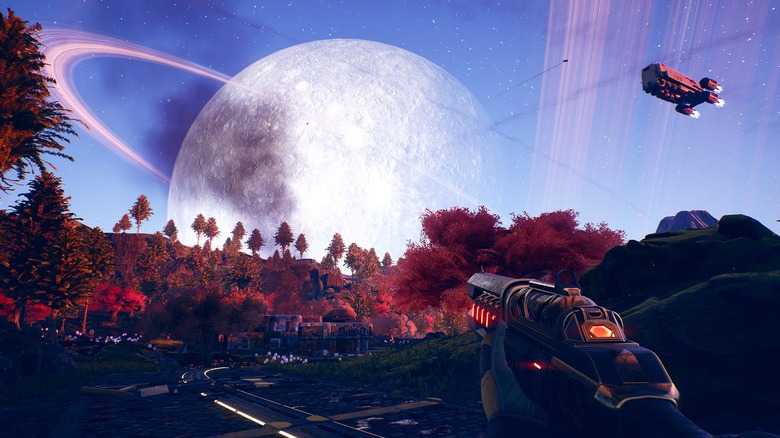 Player holding gun and looking at sci-fi town in The Outer Worlds