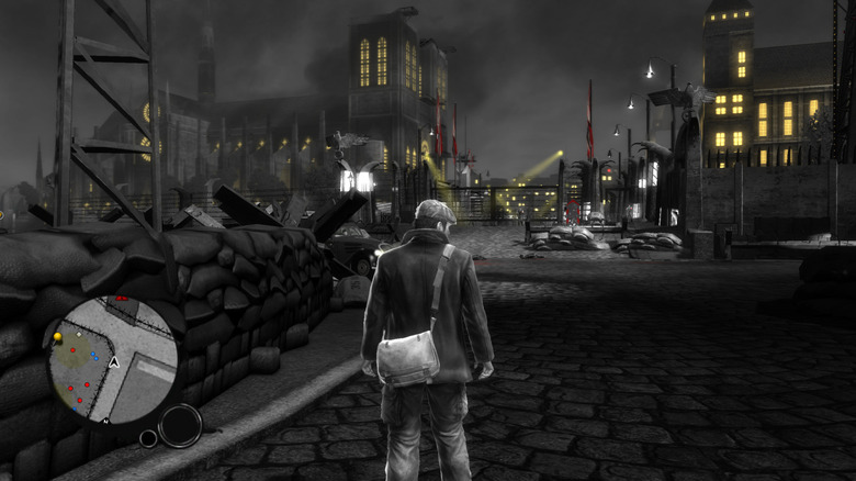 Seam stands in front of a Nazi stronghold in a screenshot from The Saboteur (2009)