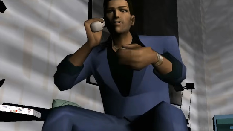 Tommy Vercetti leans forward in his chair in Grand Theft Auto Vice City