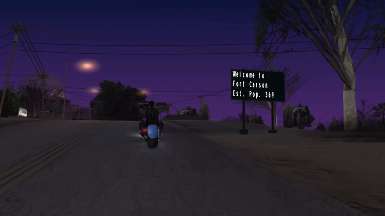 Carl "CJ" Johnson rides a motorbike past a road sign in Grand Theft Auto San Andreas