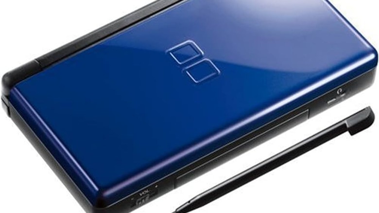 A blue Nintendo DS sits with a black stylus on a white background