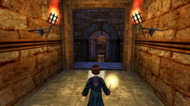 Harry Potter reads a book with a lit wand in Harry Potter and the Chamber of Secrets