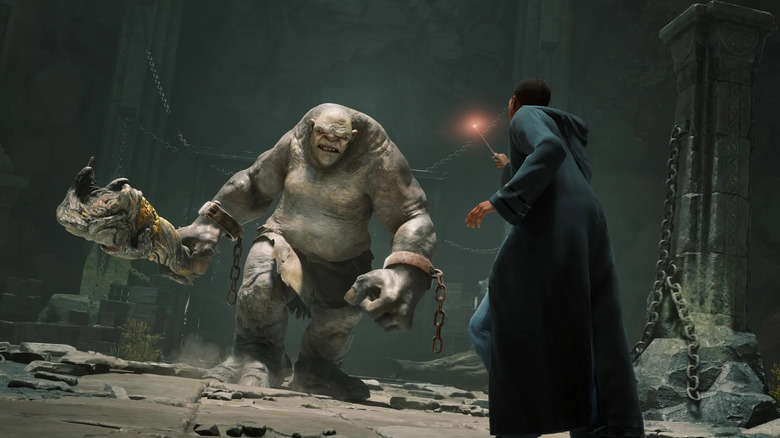 The player character confronts an advancing troll in Hogwarts Legacy