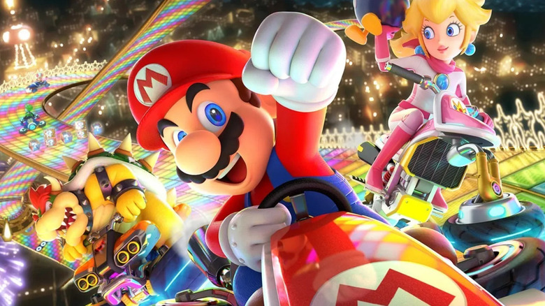 Mario drives on Rainbow Road ahead of Peach and Bowser on the cover art for Mario Kart 8 Deluxe