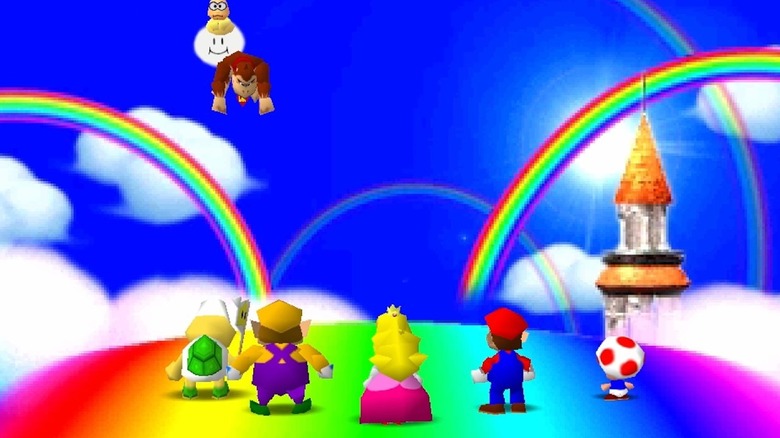 Donkey Kong is picked off a rainbow as Wario, Peach, and Mario watch in Mario Party