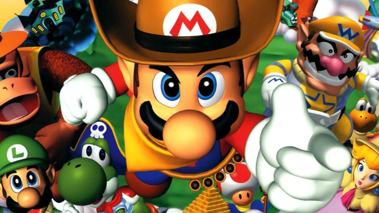 Mario points while wearing a cowboy hat on the cover art for Mario Party 2