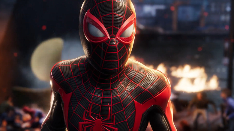 Miles Morales stands in a burning street in Marvel's Spider-Man 2