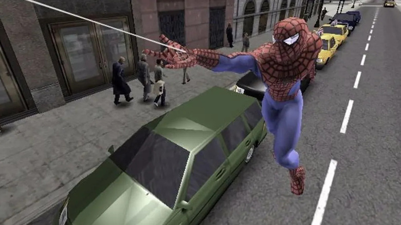 Spider-Man swings above a busy street in Spider-Man 2