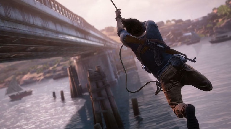 Nathan Drake swings from a bridge in Uncharted 4: A Thief's End