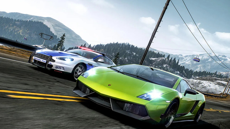 A neon green sports car races alongside a police car along a mountainous road in Need for Speed: Hot Pursuit Remastered Edition