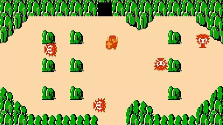 Link surrounded by boulders and octaroks in "The Legend of Zelda" on the NES
