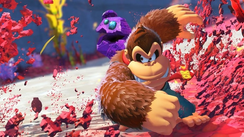 Donkey Kong punches through red dirt in Donkey Kong Bananza
