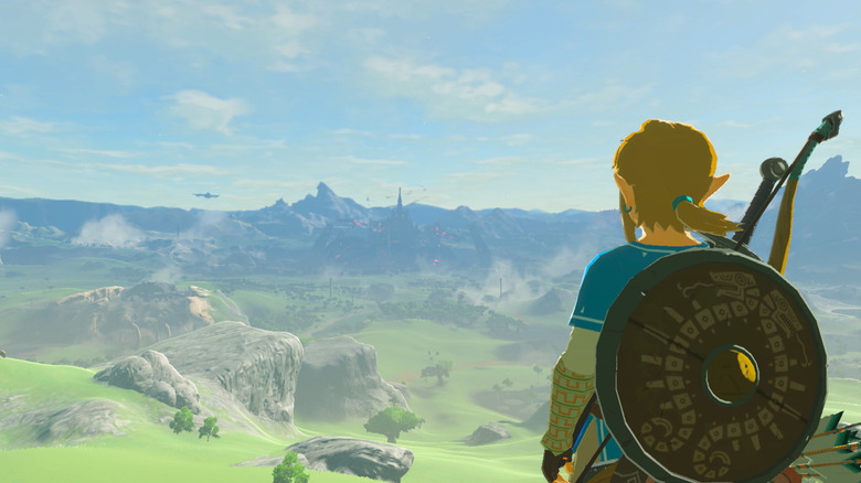 Link looks out over Hyrule at a distant castle in The Legend of Zelda: Breath of the Wild