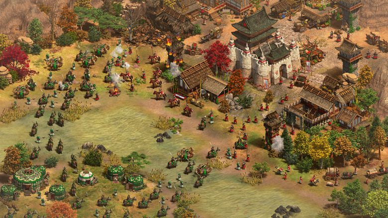 An army attacks a settlement in the forest in Age of Empires II