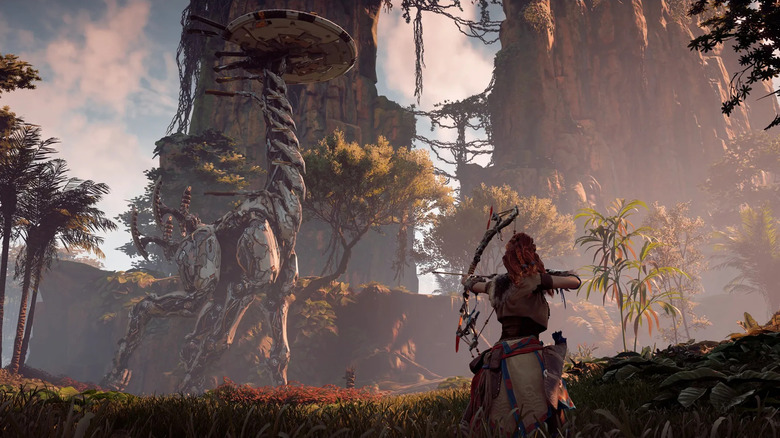 Aloy aims an arrow at a large walking machine in Horizon Zero Dawn