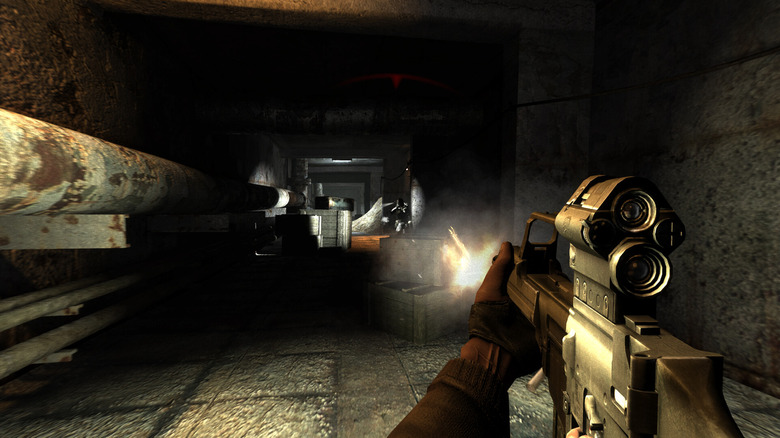 The player fires an assault rifle down a dark hallway in S.T.A.L.K.E.R.: Shadow of Chernobyl