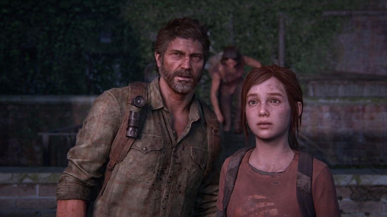 Joel Miller stands closely next to Ellie in The Last of Us
