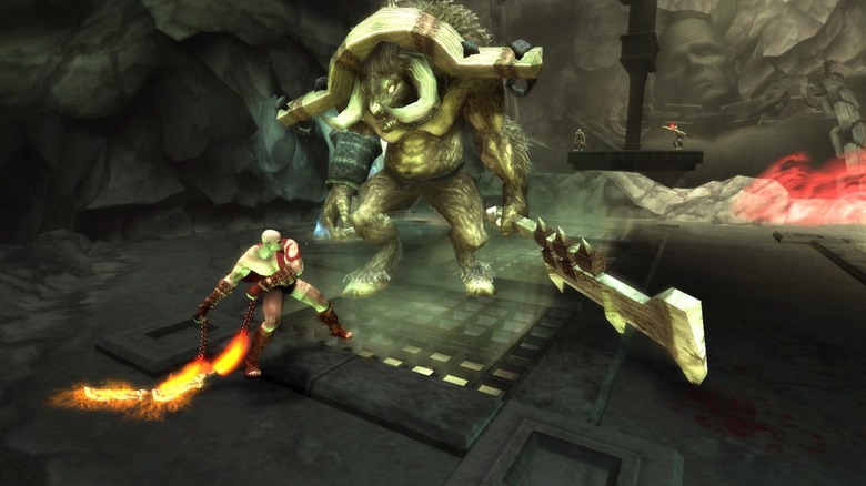 Kratos swings burning chains at a hulking minotaur in "God of War: Chains of Olympus" (2008)