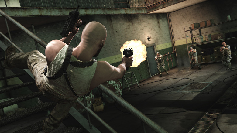 Max jumping off stairs as he fires at three enemies in Max Payne 3 (2012)