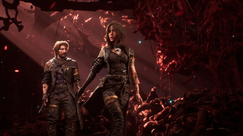 Gustave and Maelle walk through a burning wreckage in Clair Obscur: Expedition 33