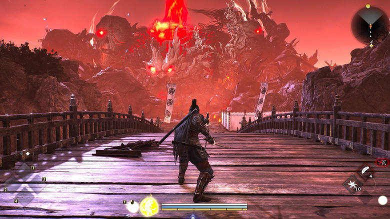 The player character standing on a bridge facing down some giant Yokai in Nioh 3