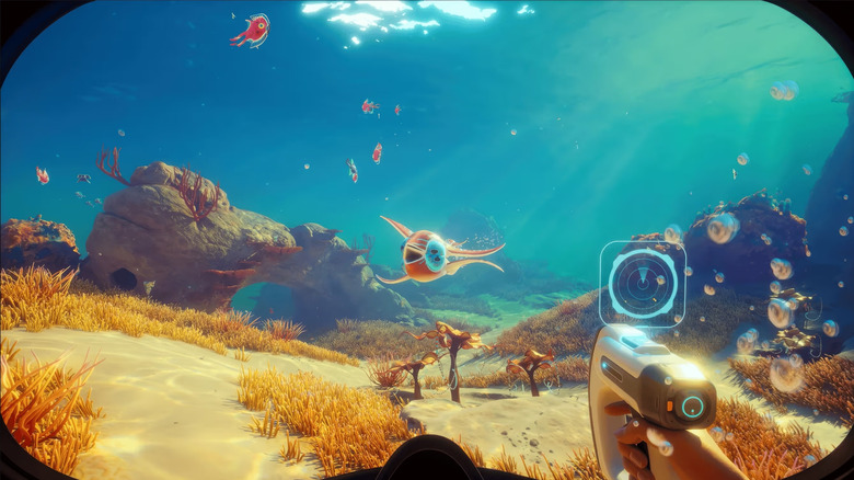 The player character uses a scanner while approaching fish in Subnautica 2
