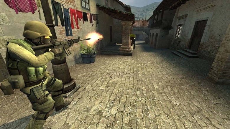 A soldier shoots an assault rifle in Counter-Strike: Source