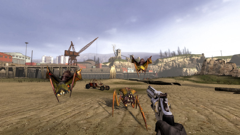 Gordon Freeman aims a pistol at approaching monsters in Half-Life 2